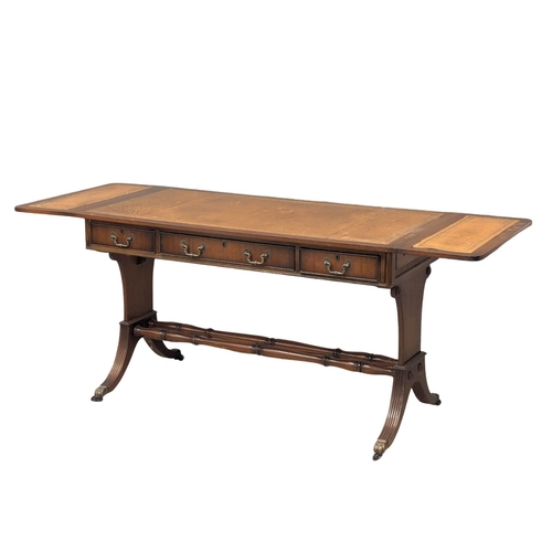 1087 - A mahogany writing desk/sofa table with leather top, 3 drawers, 3 dummy drawers and lion paw feet ca... 