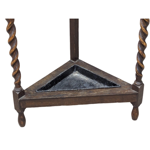 1095 - An Early 20th Century oak Barley Twist stick stand. 37x80cm