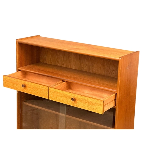 1096 - A Mid Century teak bookcase by Parker Knoll with 2 drawers. 102x30x106cm