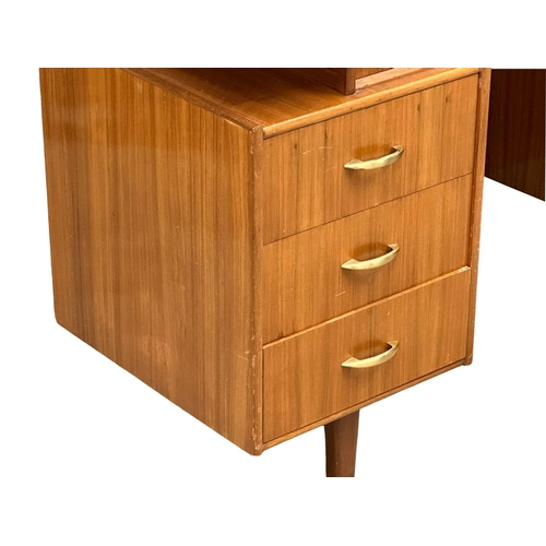 1097 - A Mid Century walnut desk/dressing table, 131cm x 49cm x 74.5cm