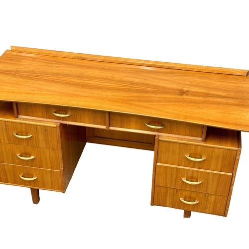 1097 - A Mid Century walnut desk/dressing table, 131cm x 49cm x 74.5cm