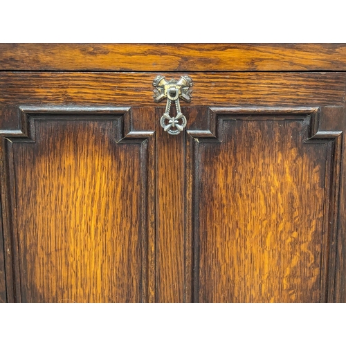 1106 - A vintage oak open bookcase with drop down paper rack. 48.5x22.5x105cm