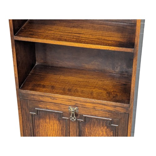 1106 - A vintage oak open bookcase with drop down paper rack. 48.5x22.5x105cm