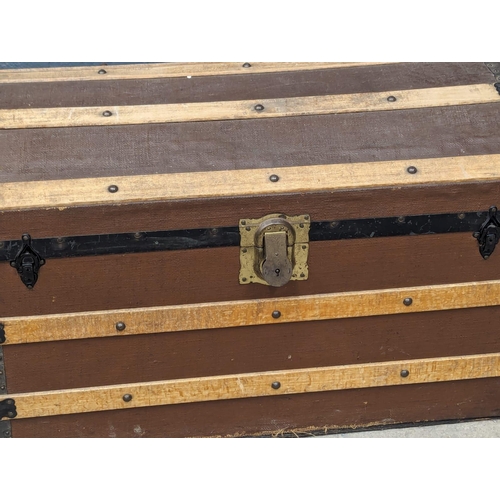 1110 - An Early 20th Century dome topped trunk. 83x48x52cm