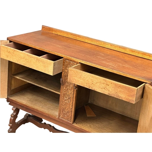 1113 - An Early/Mid 20th Century oak sideboard with 2 doors and 2 interior drawers. 137x53x103cm.