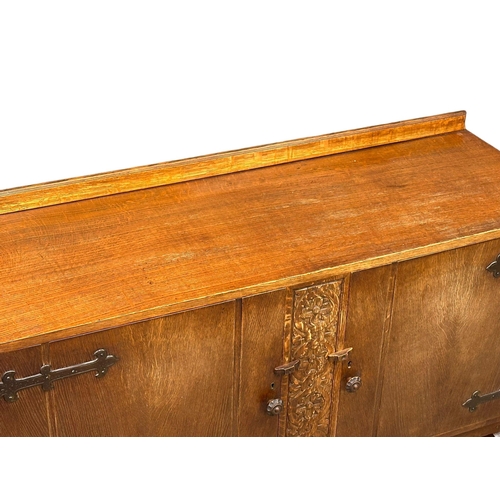 1113 - An Early/Mid 20th Century oak sideboard with 2 doors and 2 interior drawers. 137x53x103cm.