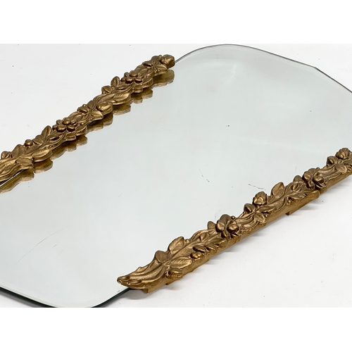 356G - A Mid 20th Century ornate gilt framed copper back bevelled mirror. 34x57cm.