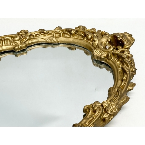 356H - A Mid 20th Century ornate gilt framed mirror. 45x64cm