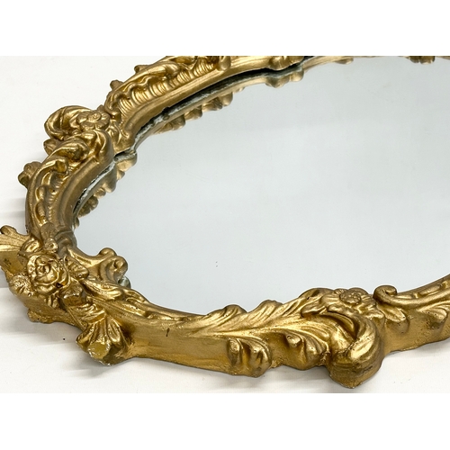 356H - A Mid 20th Century ornate gilt framed mirror. 45x64cm