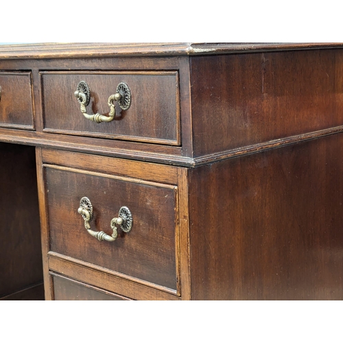 1131 - A George III style mahogany leather top desk, 118cm x 60cm x 77cm