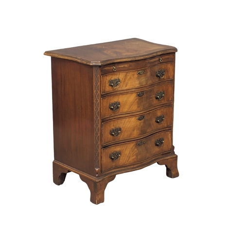 1129 - An Early 20th Century Georgian style mahogany serpentine front bachelors chest with brushing slide a... 