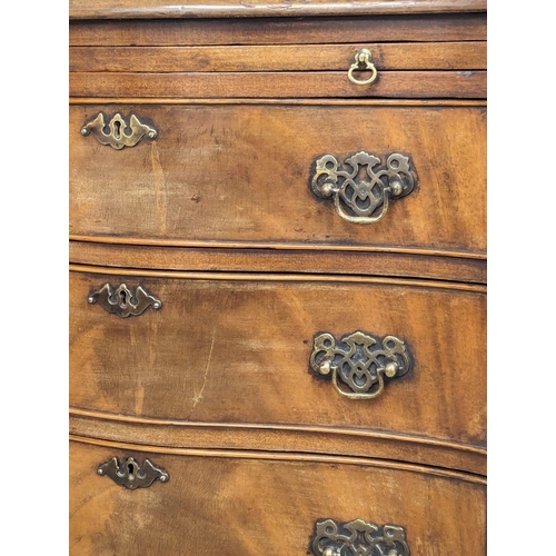 1129 - An Early 20th Century Georgian style mahogany serpentine front bachelors chest with brushing slide a... 