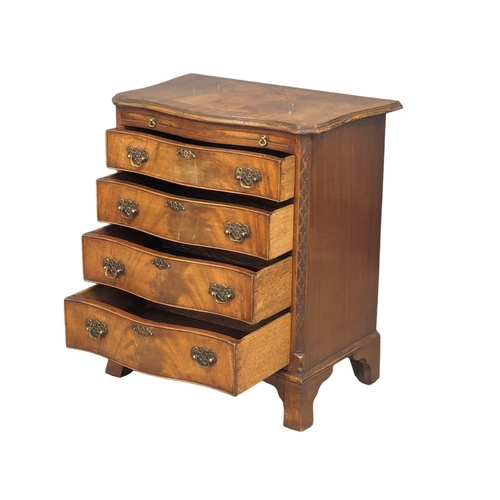 1129 - An Early 20th Century Georgian style mahogany serpentine front bachelors chest with brushing slide a... 