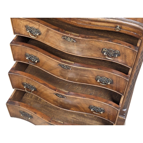 1129 - An Early 20th Century Georgian style mahogany serpentine front bachelors chest with brushing slide a... 