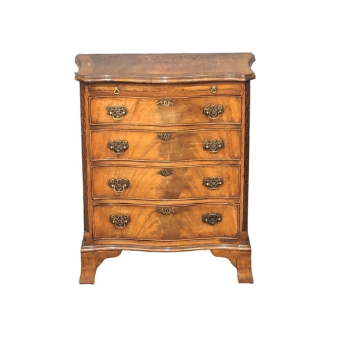 1129 - An Early 20th Century Georgian style mahogany serpentine front bachelors chest with brushing slide a... 