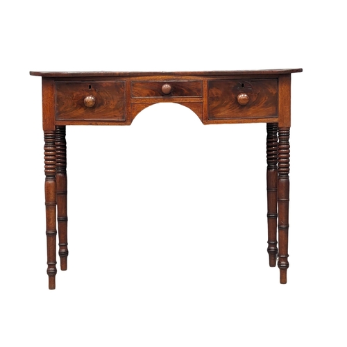 1144 - A George IV mahogany side table with 3 drawers and reeded legs. Circa 1820. 102x45x83cm