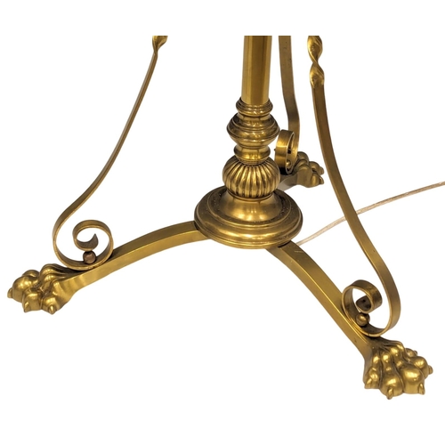 1138 - A large Early 20th Century telescopic brass standard lamp on brass lion paw feet. 180cm