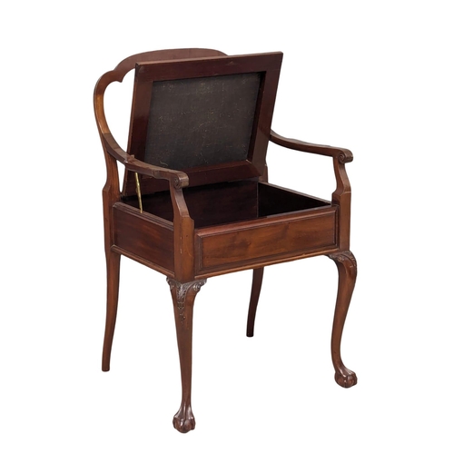 1146 - An Early 20th Century mahogany piano chair / armchair on ball and claw feet. Circa 1900-1910.