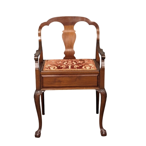 1146 - An Early 20th Century mahogany piano chair / armchair on ball and claw feet. Circa 1900-1910.