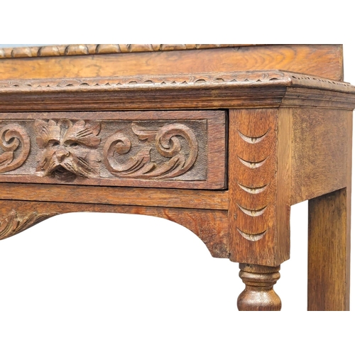 1134 - A late Victorian carved oak hall table with bobbin turn legs and Man Of The Forest handles, 107cm x ... 