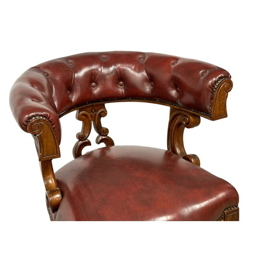 820A - A Victorian mahogany framed cockfighting style armchair. With ox-blood leather seat and back.