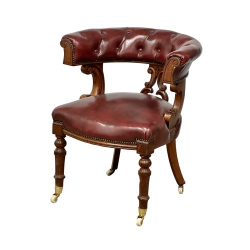 820A - A Victorian mahogany framed cockfighting style armchair. With ox-blood leather seat and back.