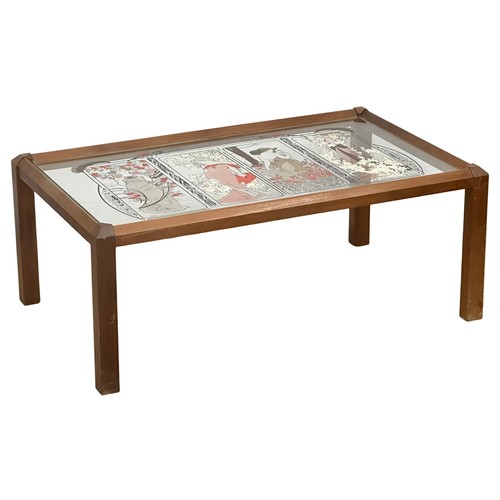 1155 - A Mid Century teak Mucha Four Seasons glass top coffee table. 100x61x40cm