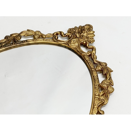 356I - A pair of vintage brass framed mirrors. 34x69cm