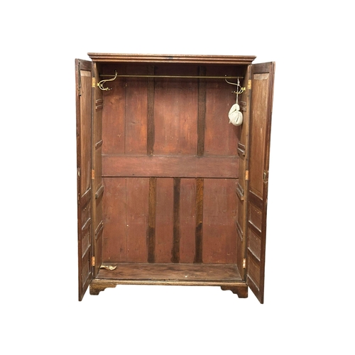 954A - A late George III mahogany double door wardrobe on bracket feet with dummy drawers. 135cm x 61.5cm x... 