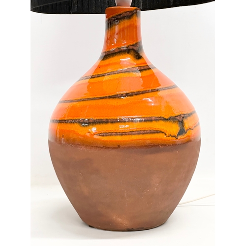 64 - A large Mid Century lava glazed terracotta table lamp. 25x53cm