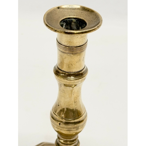 68 - A George III, Late 18th/Early 19th Century brass candlestick. 9x7.5x18cm