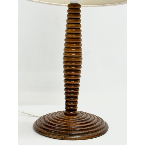 72 - An Early 20th Century turned mahogany table lamp. 50cm