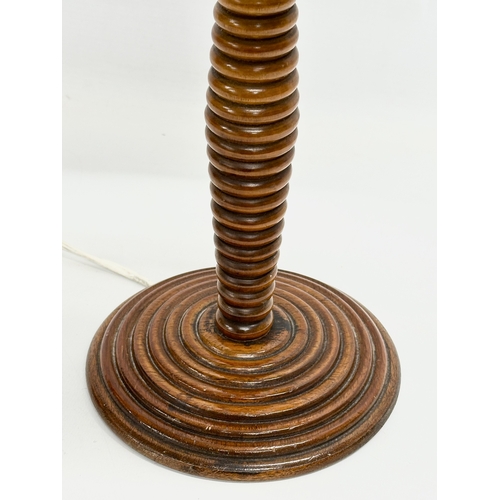 72 - An Early 20th Century turned mahogany table lamp. 50cm