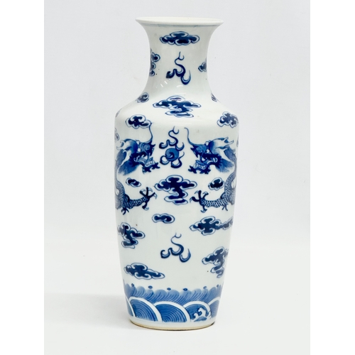 82 - A Late 19th Century Chinese vase. With two blue dragons, clouds and pearl of wisdom. Kangxi 4 charac... 