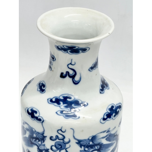 82 - A Late 19th Century Chinese vase. With two blue dragons, clouds and pearl of wisdom. Kangxi 4 charac... 