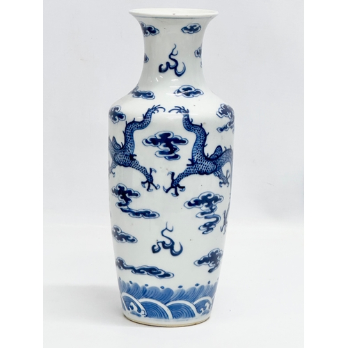 82 - A Late 19th Century Chinese vase. With two blue dragons, clouds and pearl of wisdom. Kangxi 4 charac... 