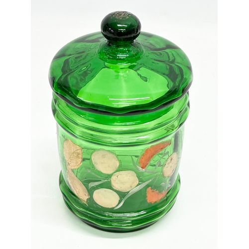 76 - 3 pieces of Late 19th Century hand painted Bristol Green glassware. 2 ewer decanters and a jar with ... 