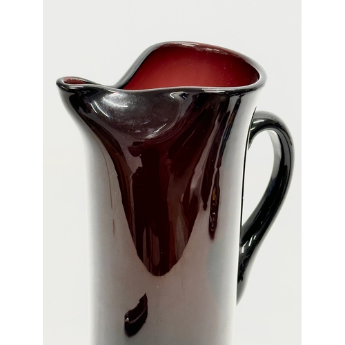 85 - A Mid Century amethyst glass pitcher jug. In the manner of Monica Bratt. 15x25cm