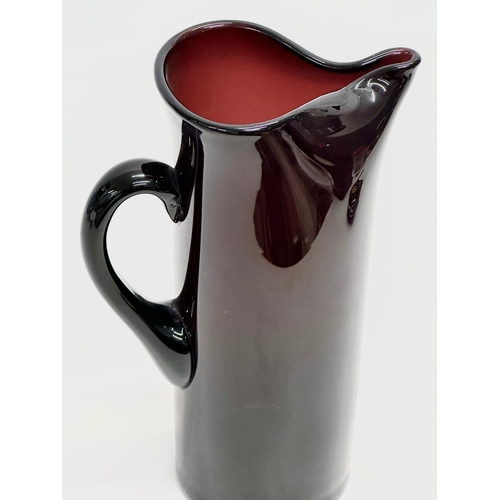 85 - A Mid Century amethyst glass pitcher jug. In the manner of Monica Bratt. 15x25cm