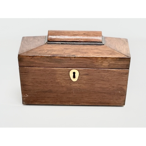 87 - A Regency rosewood sarcophagus tea caddy with nickel silver spoon. Circa 1810. 23x12x14cm