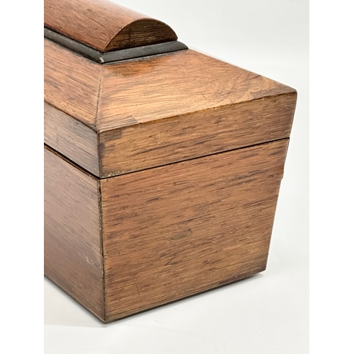 87 - A Regency rosewood sarcophagus tea caddy with nickel silver spoon. Circa 1810. 23x12x14cm