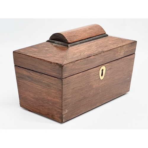 87 - A Regency rosewood sarcophagus tea caddy with nickel silver spoon. Circa 1810. 23x12x14cm