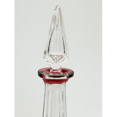 56 - Val Saint Lambert. A tall cranberry lens cut glass decanter by Val Saint Lambert. 1930/1940. 32cm.