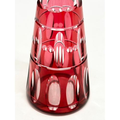 56 - Val Saint Lambert. A tall cranberry lens cut glass decanter by Val Saint Lambert. 1930/1940. 32cm.