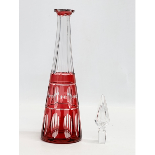 56 - Val Saint Lambert. A tall cranberry lens cut glass decanter by Val Saint Lambert. 1930/1940. 32cm.