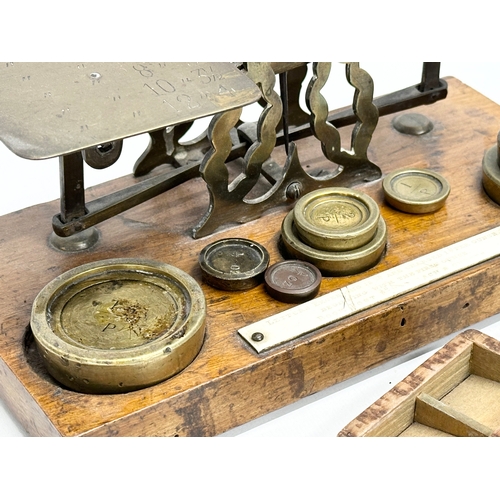 97 - A set of Late 19th Century postal scales and weights. With a wooden postage stamp box. 21.5x11x10cm