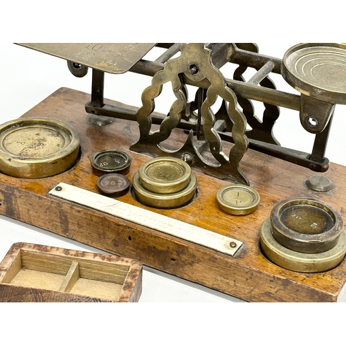 97 - A set of Late 19th Century postal scales and weights. With a wooden postage stamp box. 21.5x11x10cm