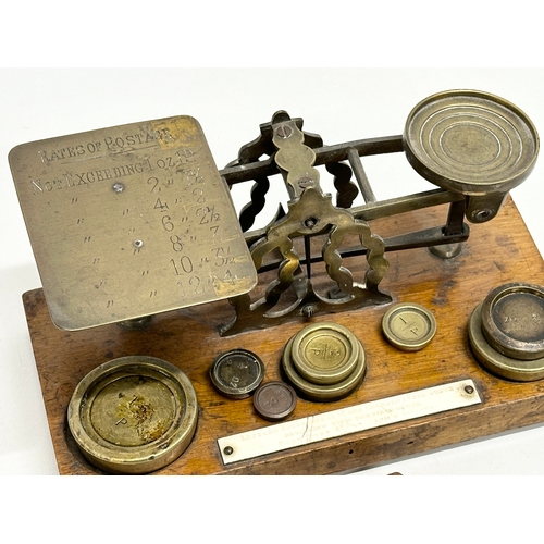 97 - A set of Late 19th Century postal scales and weights. With a wooden postage stamp box. 21.5x11x10cm