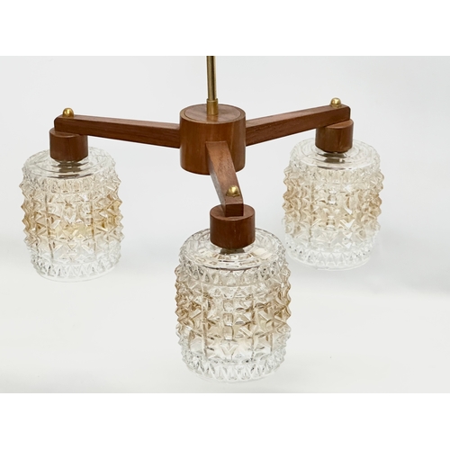 125 - A 1960’s Mid Century teak ceiling light with glass shades. 43x42x46cm