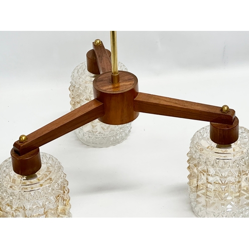 125 - A 1960’s Mid Century teak ceiling light with glass shades. 43x42x46cm